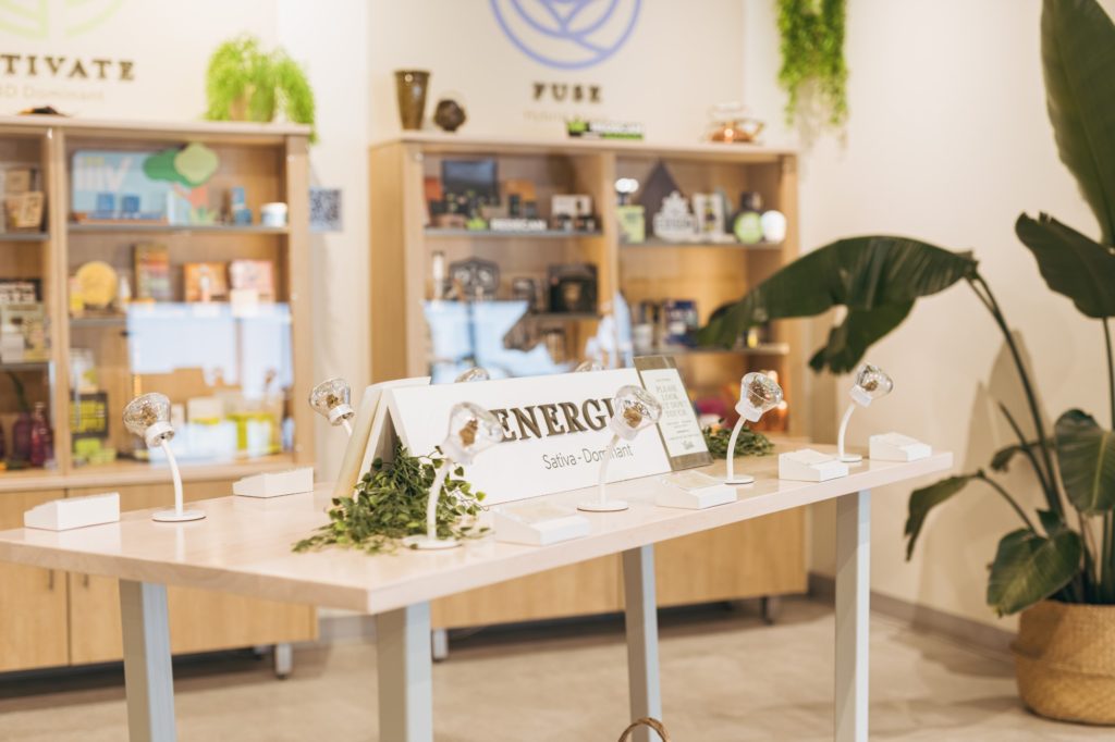 Flower Haze Ottawa Bank Street Boutique Cannabis in-store table displaying energize sativa pot products